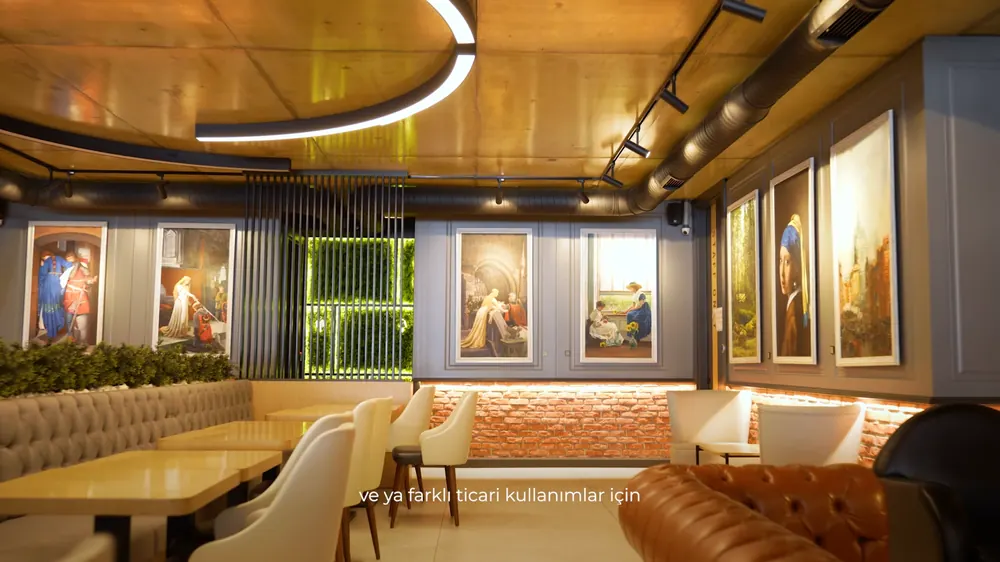 A spacious living room lined with paintings.