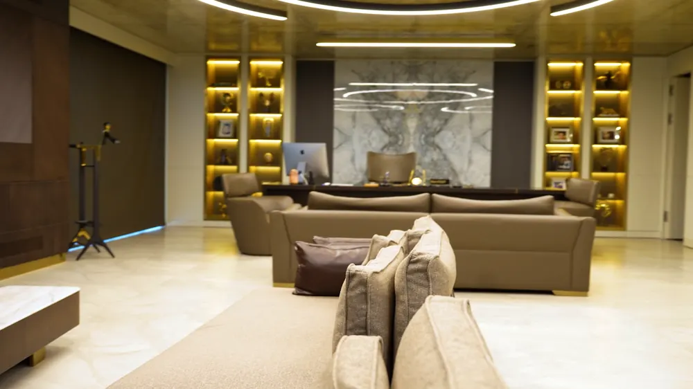 A lounge surrounded by lit shelving.